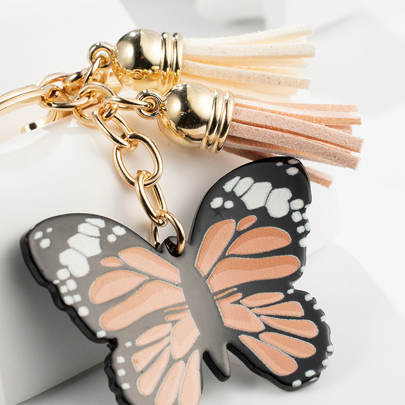 Metal Butterfly Keychain with Peach Gray Wings and Suede Tassels 3